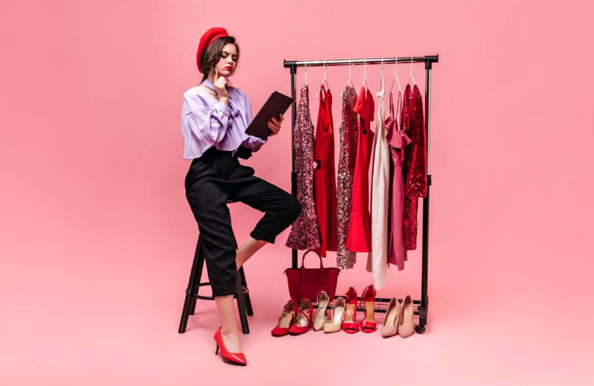 girl-stylish-outfit-red-beret-sits-chair-thoughtfully-reads-pink-background-with-shiny-clothes-shoes-1