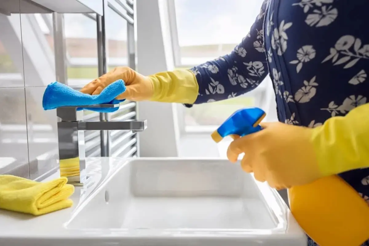 person-cleaning-bathroom1-1