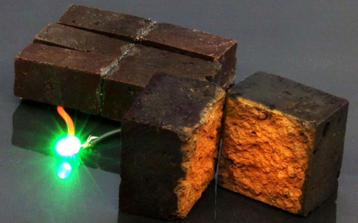 Red-brick-device-developed-by-chemists-at-Washington-University-in-St.-Louis-lights-up-a-green-light-emitting-diode-DArcy-laboratory-Washington-University-in-St.-Louis-0bad91b