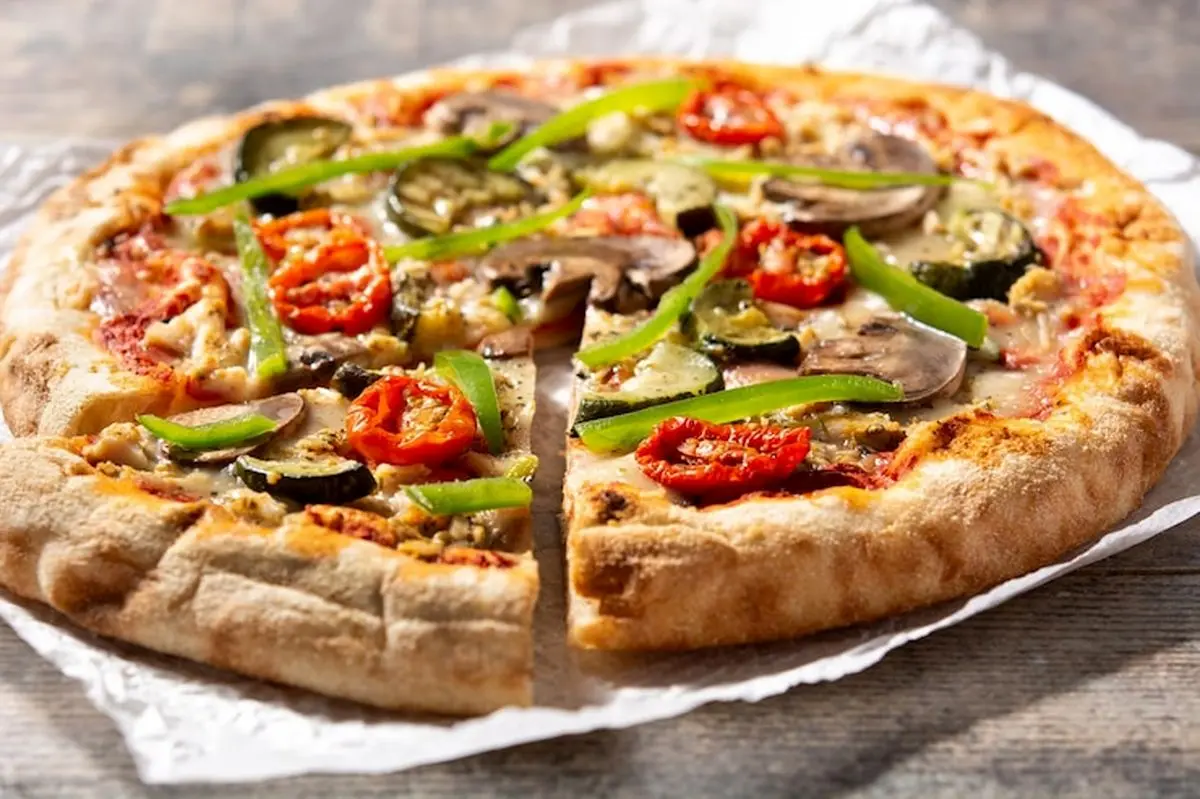vegetarian-pizza-with-zucchini-tomato-peppers-mushrooms-wooden-table_123827-21931