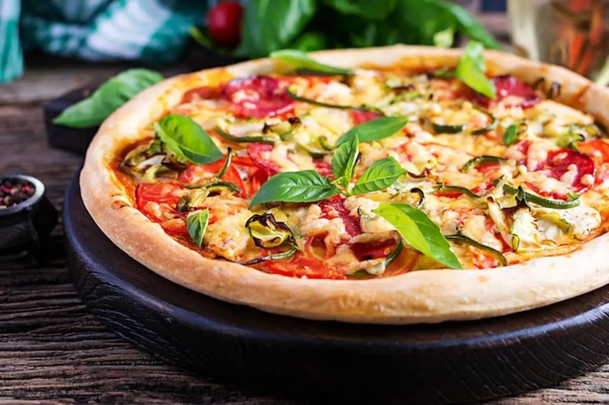 italian-pizza-with-chicken-salami-zucchini-tomatoes-herbs_2829-10838
