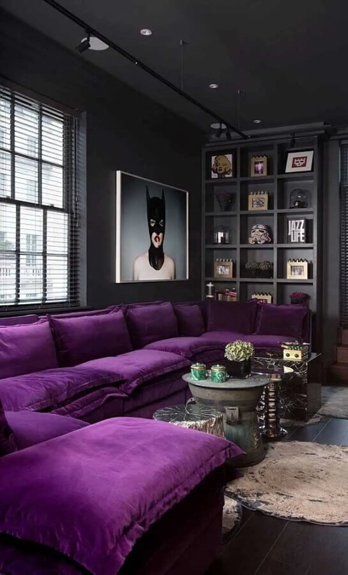 24-a-moody-contemporary-living-room-done-in-black-and-graphite-grey-a-built-in-shelf-for-displaying-a-purple-sectional-and-a-statement-artwork