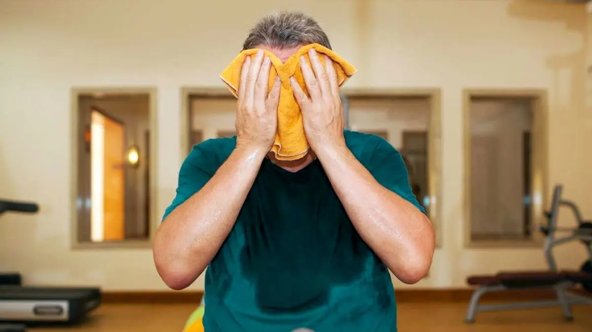 Man-Wiping-Face-With-Towel-1296x728-header