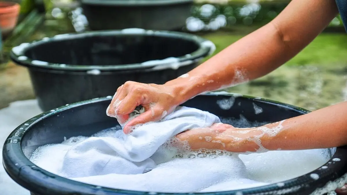 female-hands-washing-clothes-in-basin.-wash-clothing-by-hand-with-detergent.-water-will-wash-over-wash-machine.-hand-washing.selective-focus-and-space-for-text