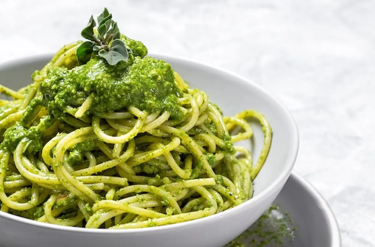 spaghetti-with-homemade-pesto-sauce-gray-background_58460-6467