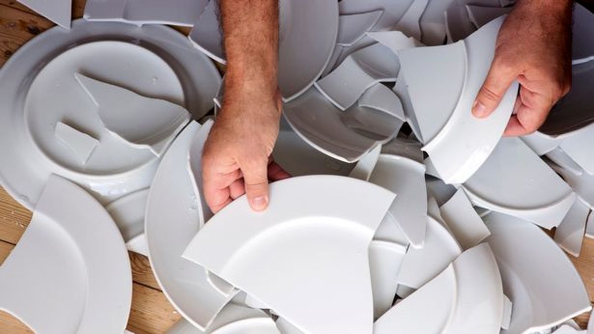 0_hands-picking-up-broken-white-plates-of-floor