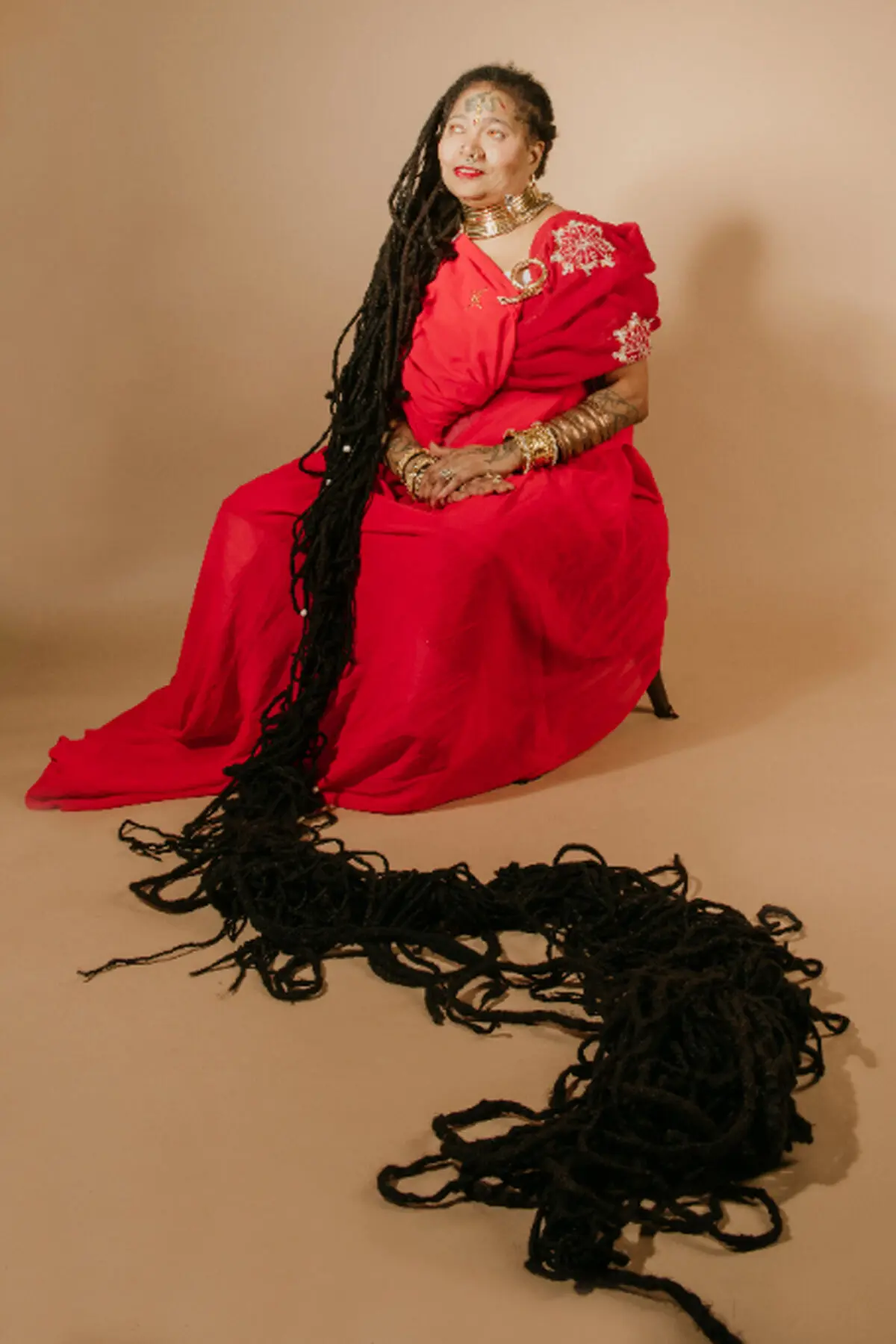 asha-mandela-with-locs-extended-across-the-floor_tcm55-713388