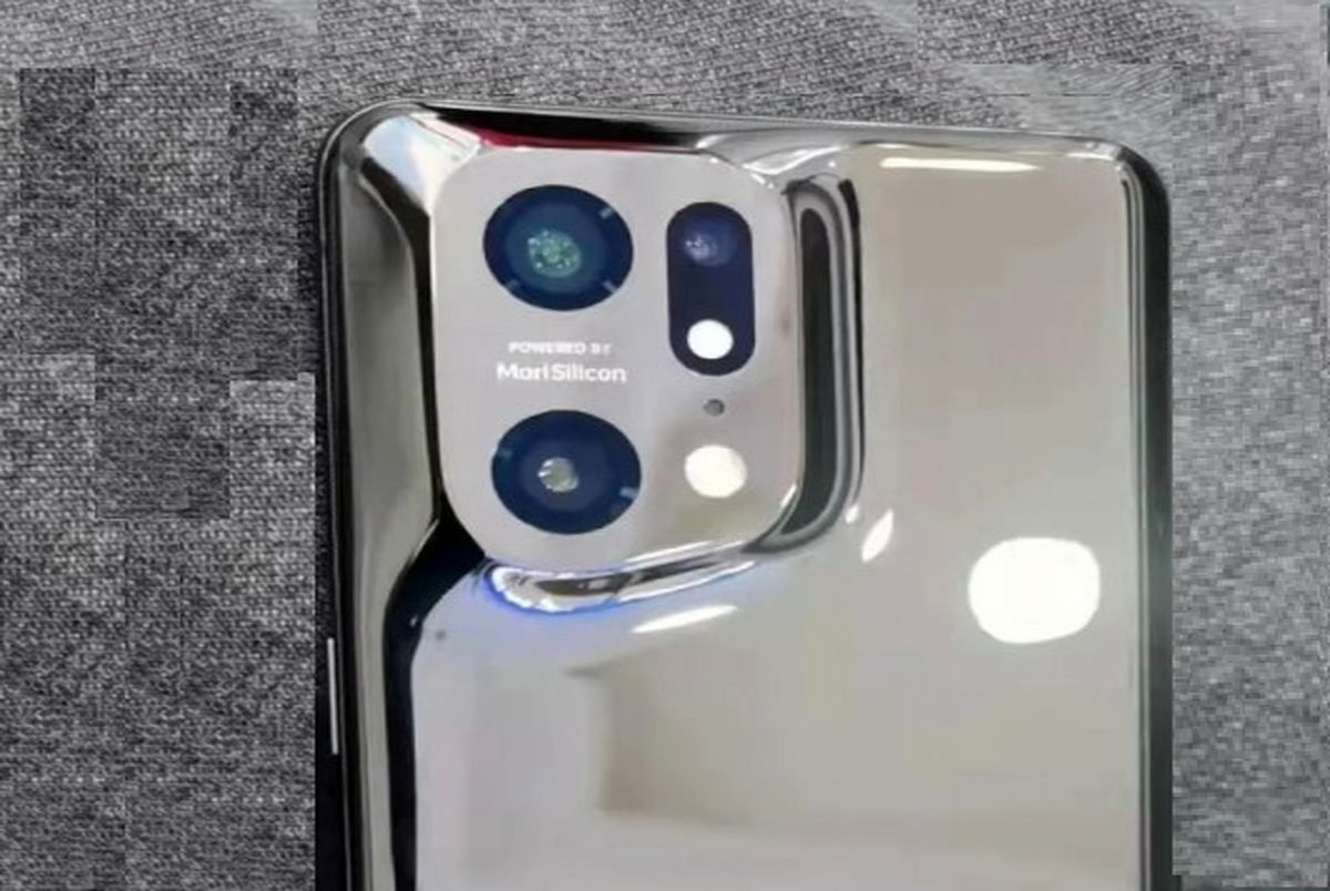 Oppo Find X5 Pro poses for the camera with reflective back